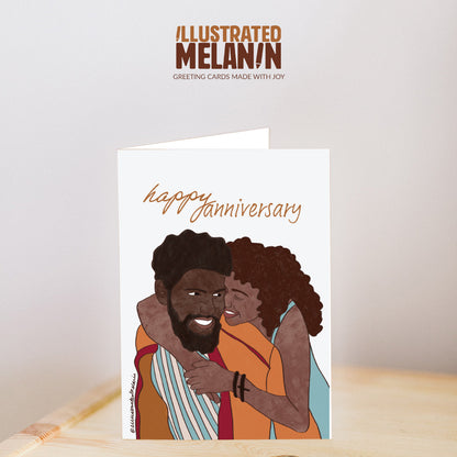 white greeting card reads happy anniversary above an illustration of a black couple holding onto each other while smiling